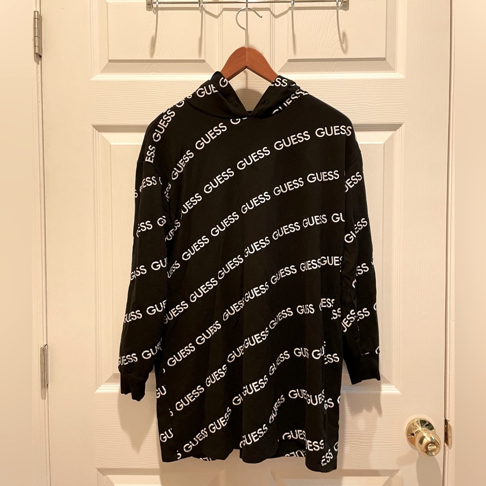 Black oversized Guess hoodie with white ‘GUESS’ logos all over